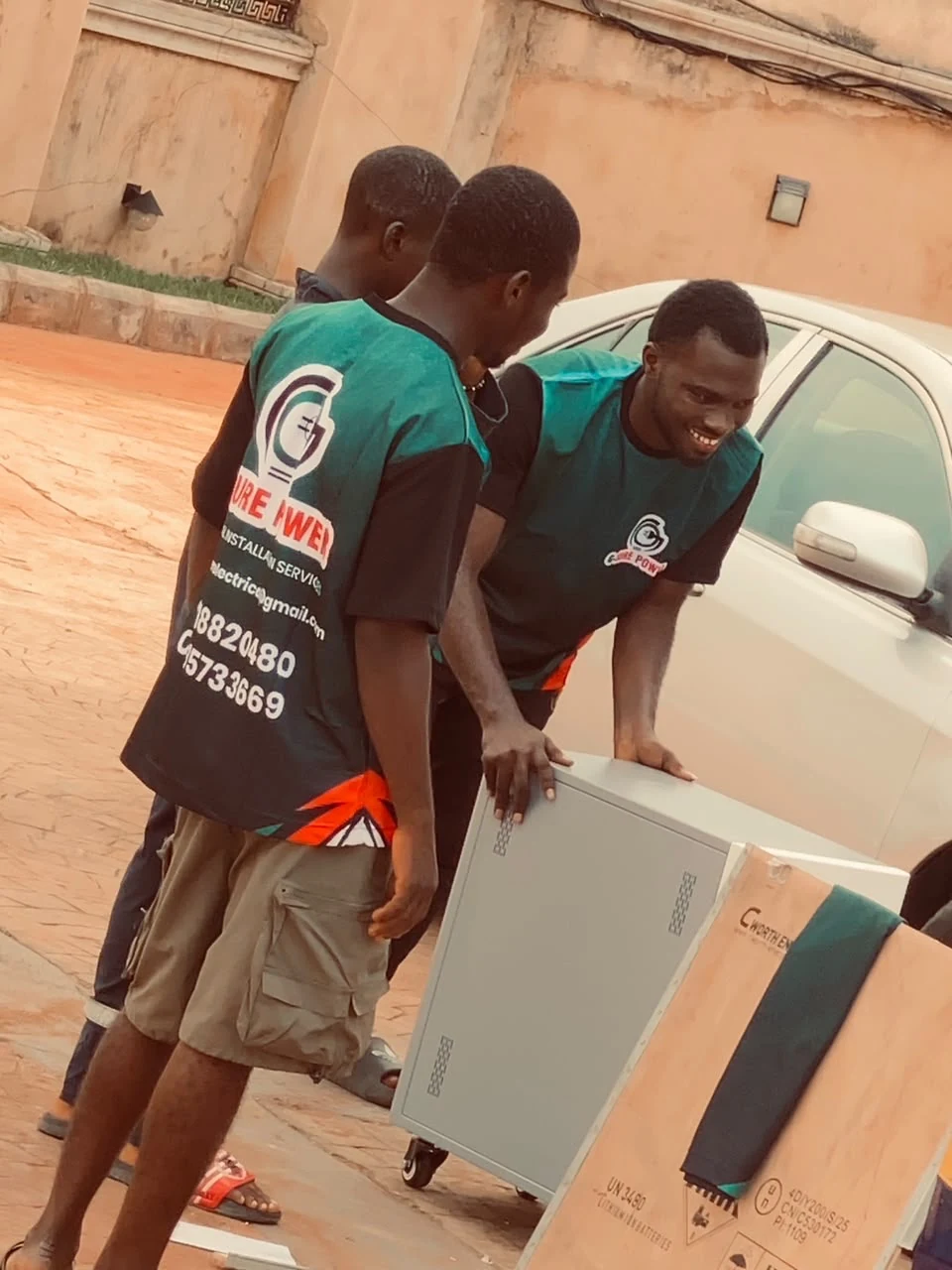 Technicians handling electrical equipment