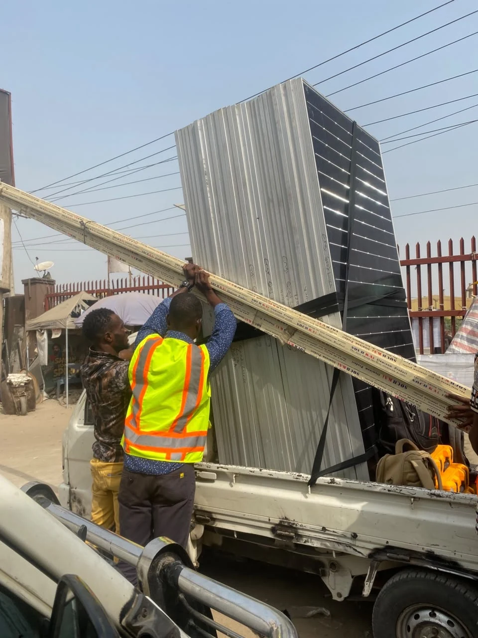 Technicians loading electrical equipment for transport